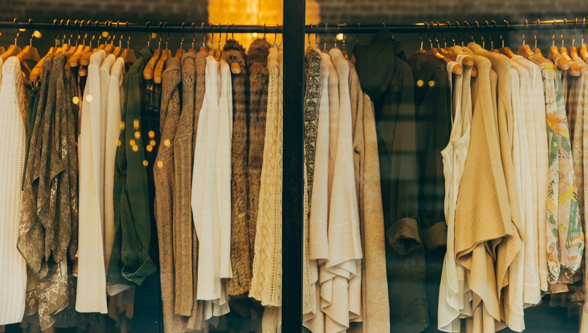 A warmly lit rail of clothing