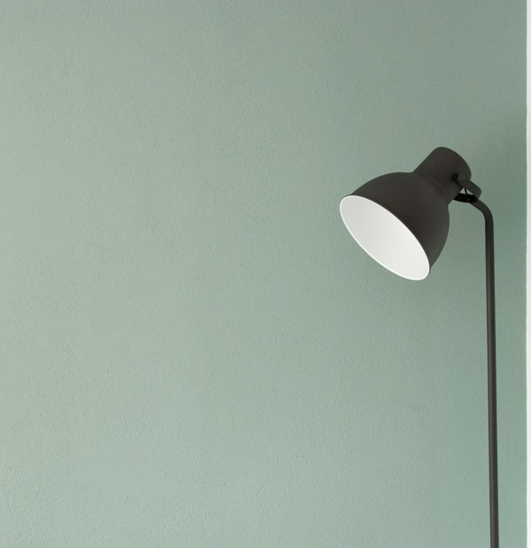 Minimal green wall and angled desk lamp