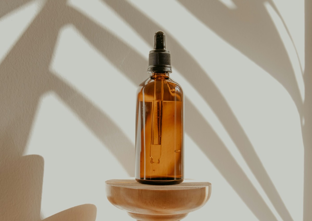 Amber skincare bottle in soft natural light