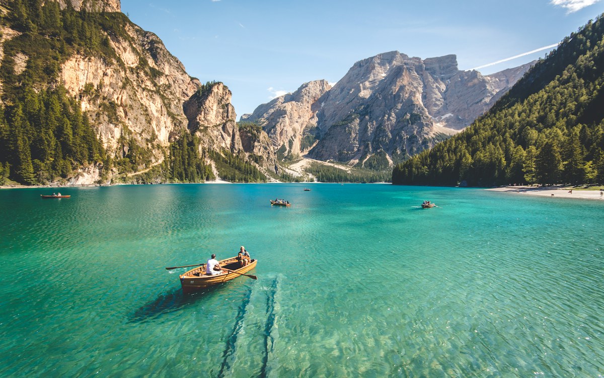 Clear turquoise alpine lake surrounded by mountains