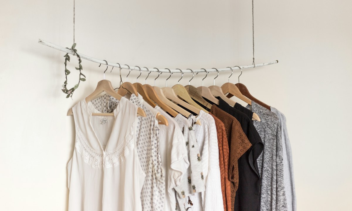 Neatly arranged clothes on a hanging rail